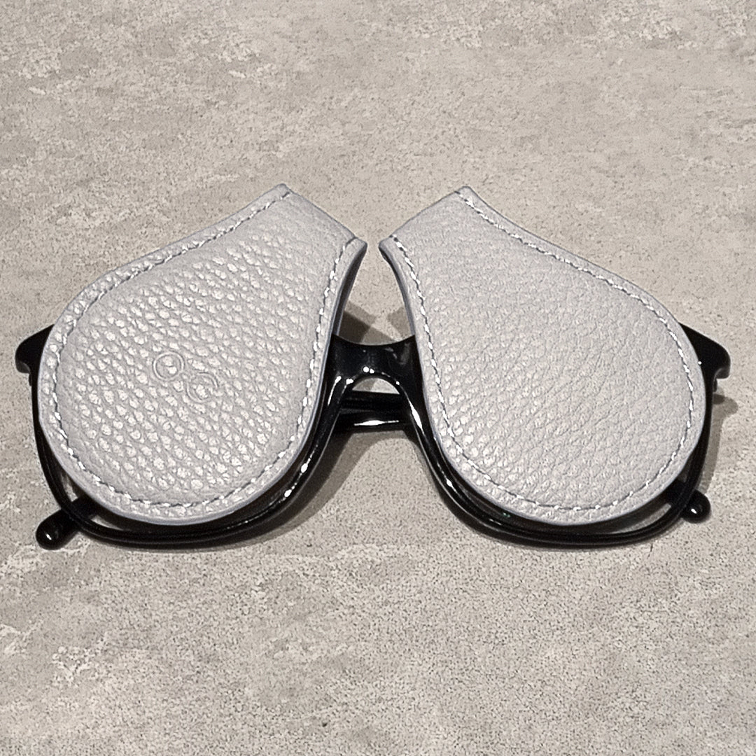 two gray magnetic eyewear protectors on glasses