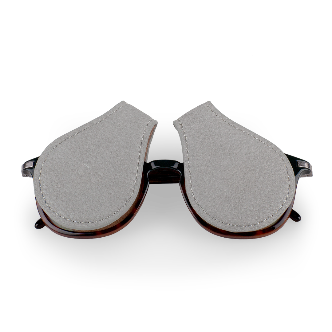 two gray lens protectors for your sunglasses that clip on to the lens